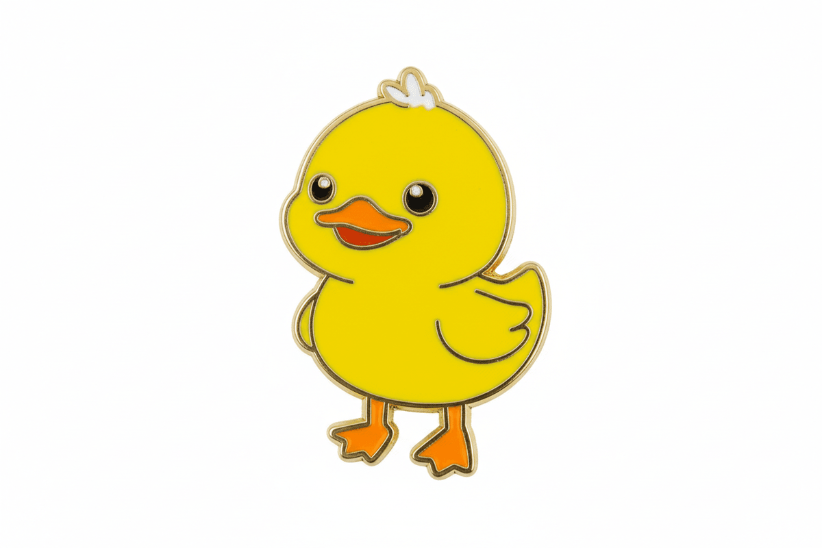 A colorful enamel pin shaped like a cute yellow duck.
