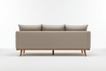 The back view of a neutral-colored ottoman sofa with wooden legs.