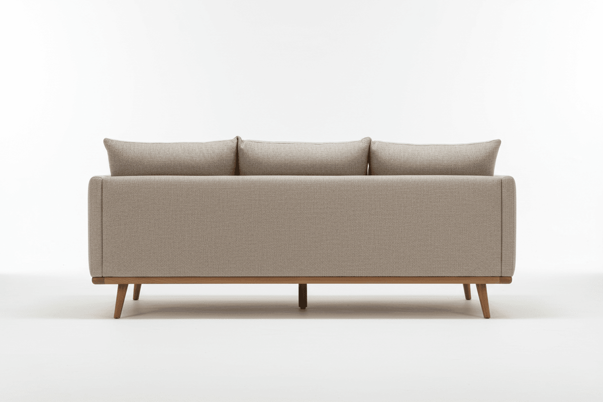 The back view of a neutral-colored ottoman sofa with wooden legs.